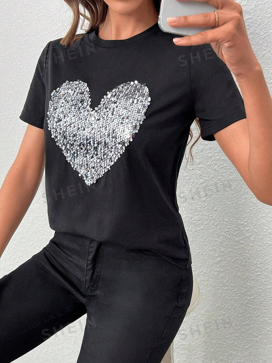The Essence of Love: Heart Sequin Detail <a href="https://canaryhouze.com/collections/tshirt" target="_blank" rel="noopener">Tee</a> is the perfect addition to your wardrobe. The heart-shaped sequin detailing adds a touch of sparkle and charm to this classic tee. Made with high-quality materials, it provides both comfort and style. A must-have for any fashion-forward individual.