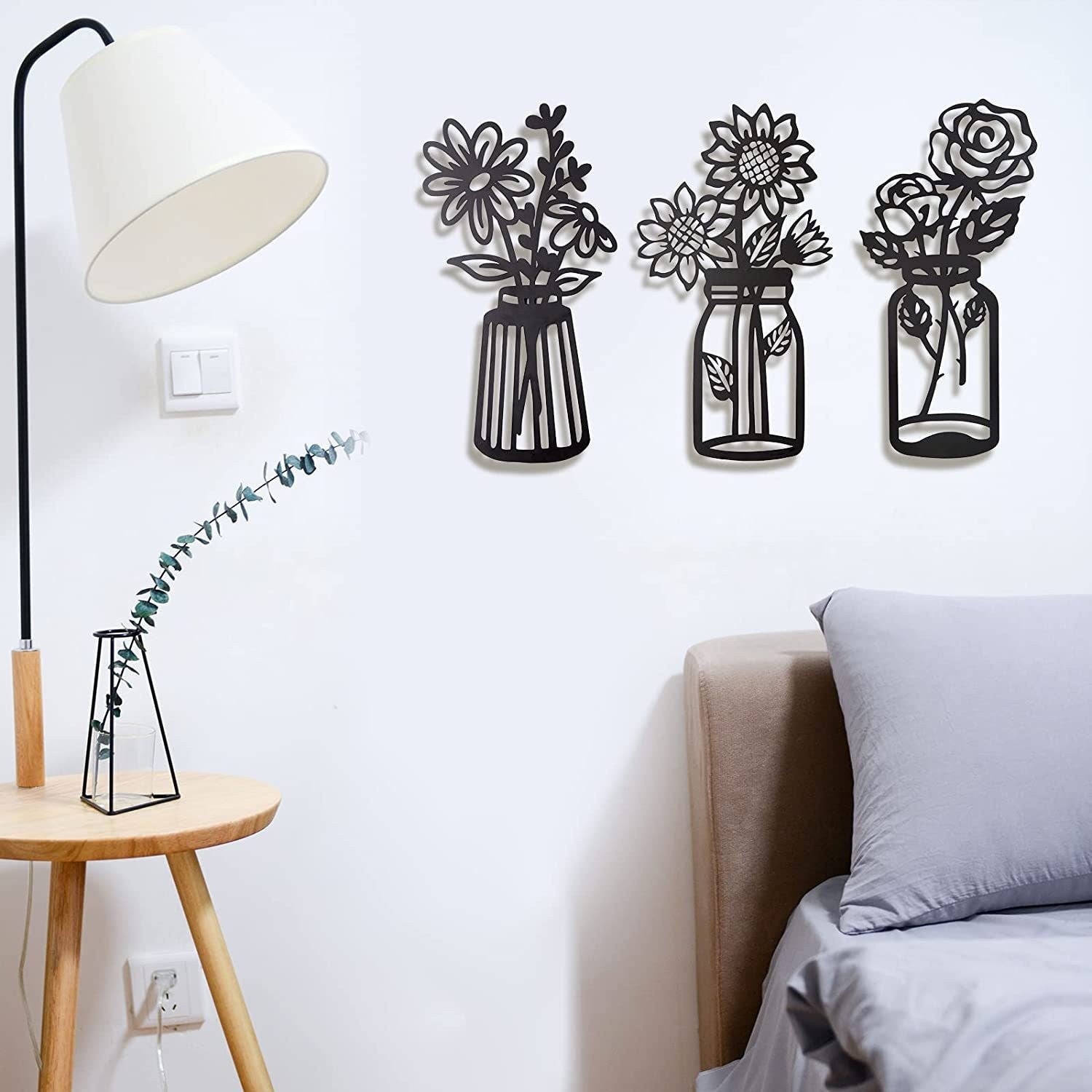 Bring a touch of elegance and modern style to your home with this black metal art flower wall decor set. This eye-catching set of wall art features a modern curved iron vase design, perfect for enhancing any wall in your home. It's sure to be a stunning addition to your decor.