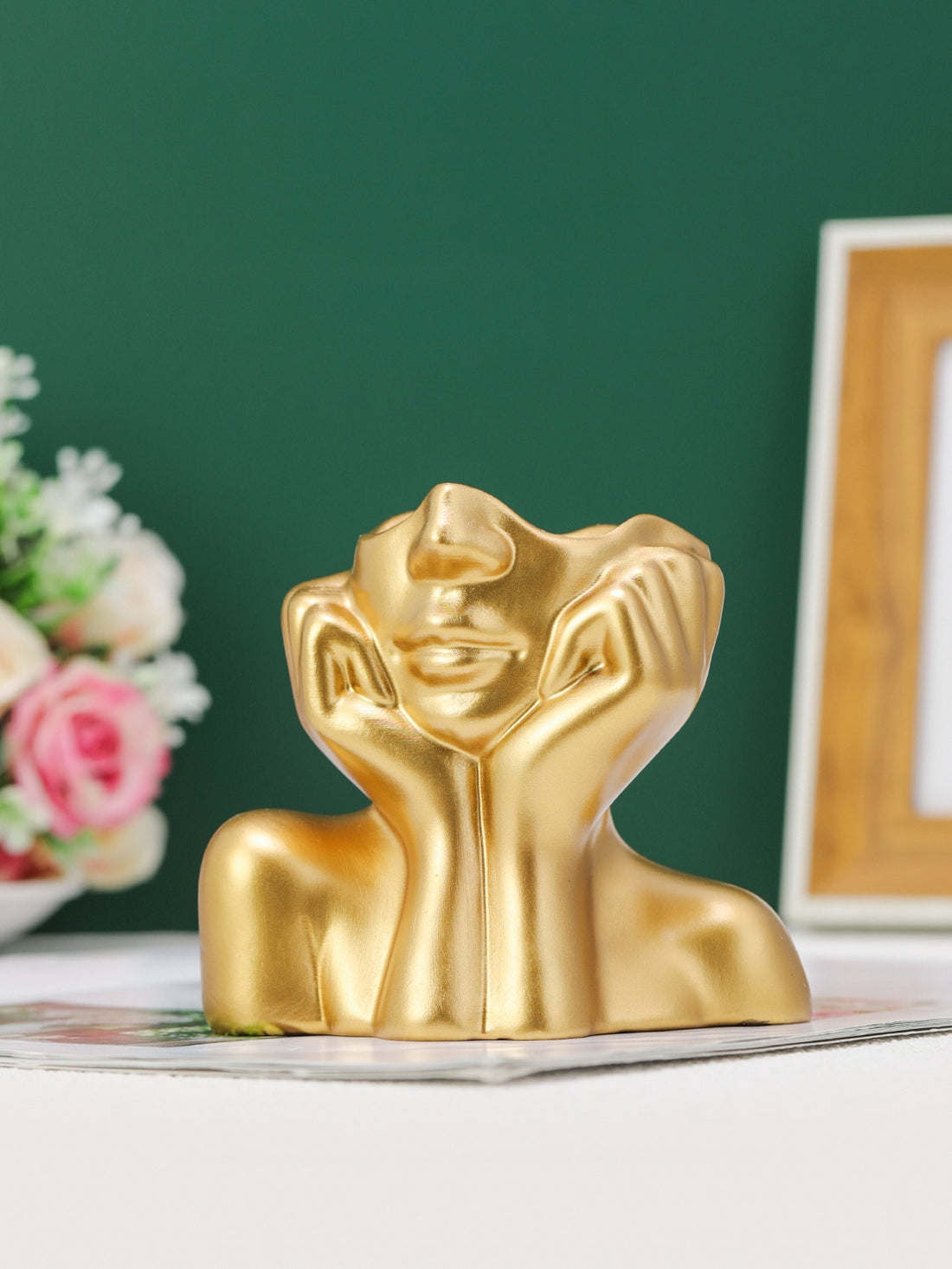 This Nordic Golden Face Holding Flower Vase boasts a unique body shape design, adding a touch of elegance to any space. Crafted with expert precision and careful attention to detail, this vase is sure to impress. Its golden face adds a touch of luxury, while its practical design allows for easy display and holding of your favorite flowers.