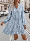 This Boho Chic Smock Dress features a beautiful allover print and tie-neck detailing, creating a stylish and feminine look. The lantern sleeves add a touch of whimsy while the smock silhouette provides a comfortable and flattering fit. Perfect for any occasion, this dress combines fashion with functionality.