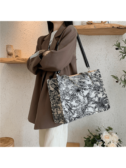 "Upgrade your style game with this Vintage Boho Canvas Large Shopper Bag. With a trendy floral graphic and minimalist design, this bag is perfect for work and travel. The durable canvas material ensures long-lasting use. Add a touch of vintage charm to your wardrobe with this must-have accessory."
