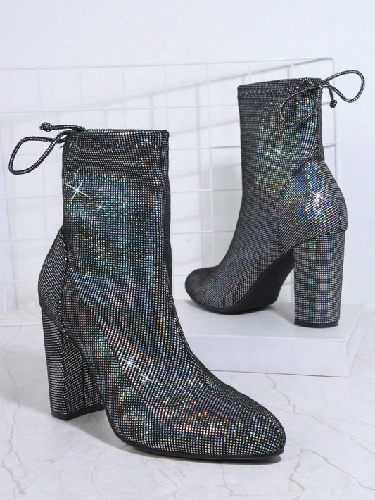 Shine like a fashion icon with Sparkle in Style: Glitter Knot Back Chunky <a href="https://canaryhouze.com/collections/women-boots" target="_blank" rel="noopener">Boots</a>. These boots feature a trendy knot back design and chunky heels, perfect for making a bold statement. Step out in confidence and elevate your style game with a touch of glitter.