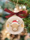 This Heifer Hear the Bells Christmas ornament features a comical and charming Highland cow design, perfect for adding a touch of humor to your holiday decor. Made with high-quality materials, it's a durable and delightful addition to any Christmas tree. Celebrate the season with this unique and festive ornament.