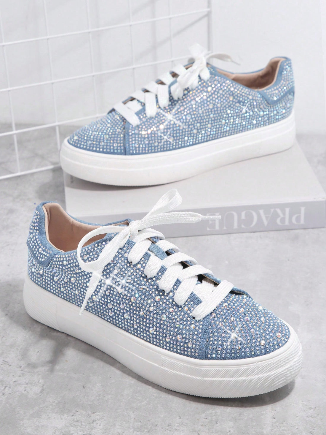 These Sparkling Elegance canvas sneakers feature rhinestone embellishments, with a lace-up closure for a secure fit. Their comfortable design makes them perfect for everyday wear. The rhinestones add a touch of glamour to the canvas, making these sneakers an elegant addition to any look.