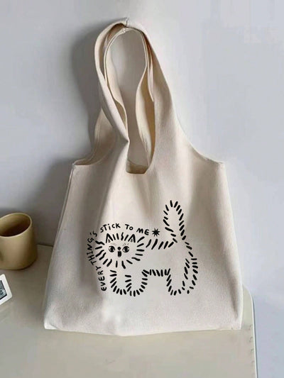 Introducing the Charming Cat Print Canvas Tote Bag - your perfect companion for shopping and daily errands. With its charming cat print, this tote bag is both stylish and functional. Made of durable canvas, it can carry all your essentials while adding a touch of whimsy to your wardrobe.