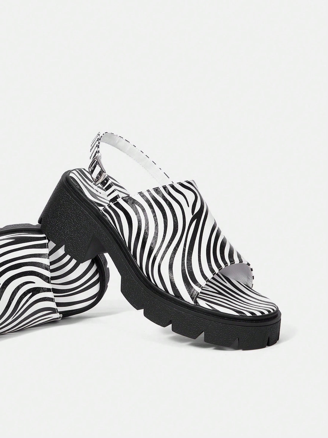 These Zebra Striped Style Round Toe <a href="https://canaryhouze.com/collections/women-canvas-shoes" target="_blank" rel="noopener">Sandals</a> are perfect for daily wear and the workplace. Made with a classic black and white design, these sandals offer both style and versatility. With their round toe shape, they provide comfort while adding a touch of sophistication to any outfit. Upgrade your wardrobe with these must-have sandals.