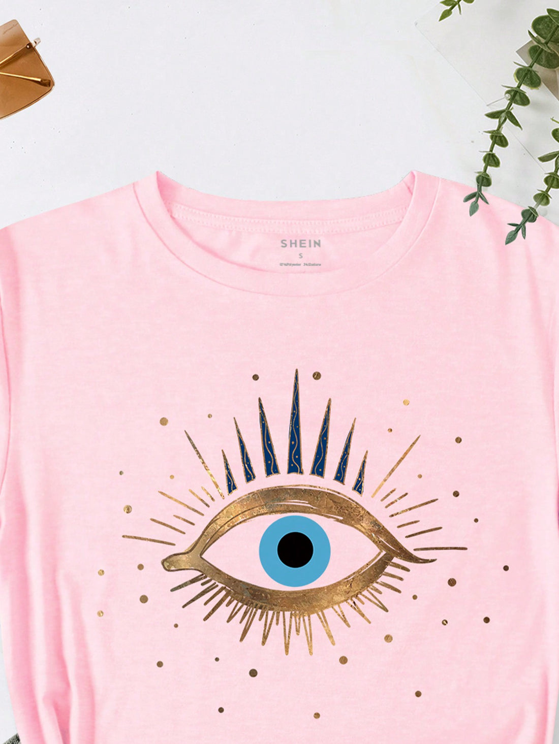 Stay stylish and chic with our Women's Eyelashes Pattern Printed Short Sleeve T-Shirt. Designed to enhance any outfit, this tee offers a unique eyelash pattern for a flirty touch. Made with high-quality material, it's comfortable enough for all-day wear. Elevate your wardrobe with this trendy and eye-catching piece.