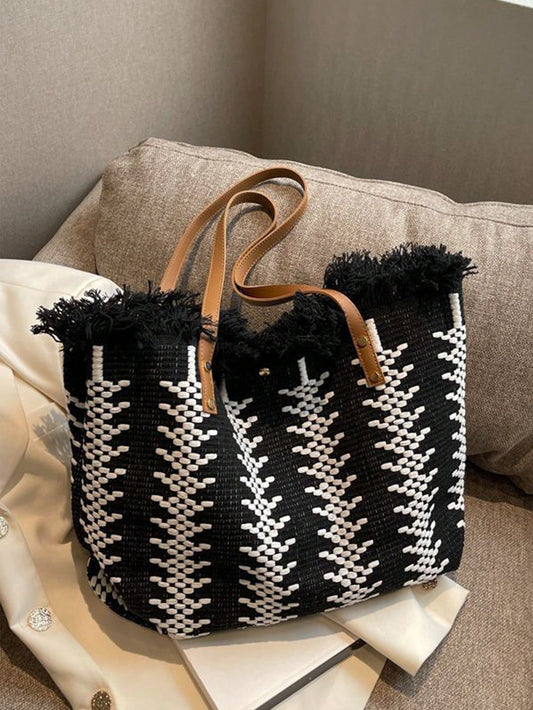 Stay stylish and organized for your beach days with our Summer Chic Straw <a href="https://canaryhouze.com/collections/canvas-tote-bags" target="_blank" rel="noopener">Tote Bag</a>. Made of lightweight straw and featuring fringed details, it's perfect for carrying your essentials. Enjoy a fashionable and carefree summer with this must-have accessory.