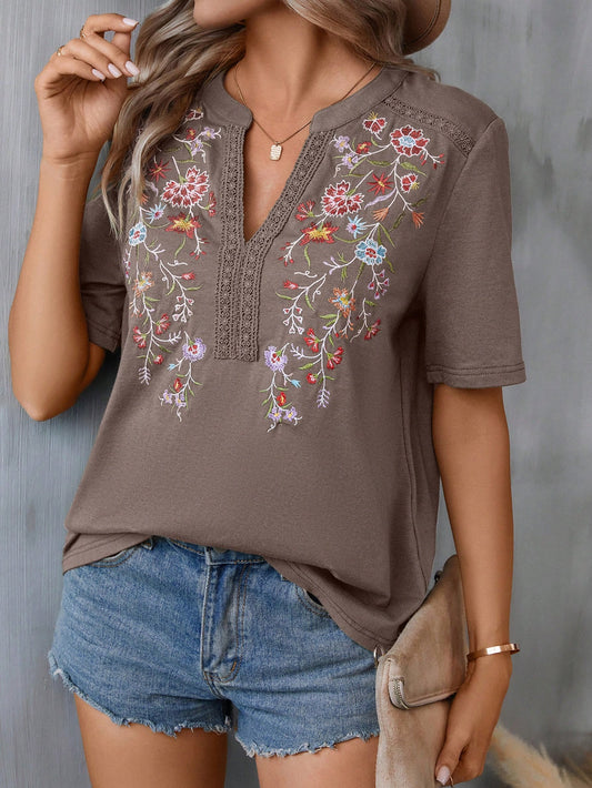 Introducing Blooming Beauty: A women's t-shirt that combines floral embroidery with a stylish notched collar. Stay on trend and add a touch of feminine detail to your wardrobe with this must-have piece. Expertly crafted with quality materials, this t-shirt offers both style and comfort, making it a versatile addition to any outfit.