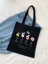This stylish black <a href="https://canaryhouze.com/collections/canvas-tote-bags" target="_blank" rel="noopener">tote bag</a> combines fashion with function, featuring a trendy plant, butterfly, and love print that adds a touch of nature to your outfit. Perfect for shopping or outdoor adventures, its spacious design allows you to carry all your essentials with ease. Stay on-trend and organized with this chic tote bag.