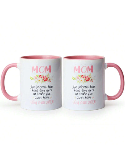 This white coffee <a href="https://canaryhouze.com/collections/mug" target="_blank" rel="noopener">mug</a> with lid makes for a humorous and practical gift for moms. The bold, printed text "No Matter What Ugly Children" adds a playful touch, while the lid keeps drinks warm and spill-free. Perfect for any coffee-loving mom who knows the joys (and challenges) of raising children.
