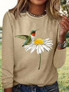 Introducing our Whimsical Bird and Flower Print T-Shirt - the perfect casual long sleeve for spring-fall. Featuring a charming design of colorful birds and flowers, this crew neck shirt is sure to elevate any outfit. Stay comfortable and stylish with this versatile piece.