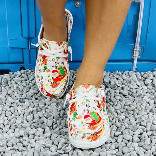 Add a touch of holiday cheer to your wardrobe with Festive Footwear: Women's Cartoon Santa Claus Pattern Loafers. These cozy canvas shoes feature a playful design that is perfect for spreading Christmas joy. Step into comfort and style this season!