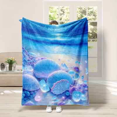 This shell-inspired flannel beach blanket is made with a vibrant digital print and soft fabric that provides comfort at home, the office, or while traveling. The warm fabric is designed to keep you cozy in cold temperatures while you relax.