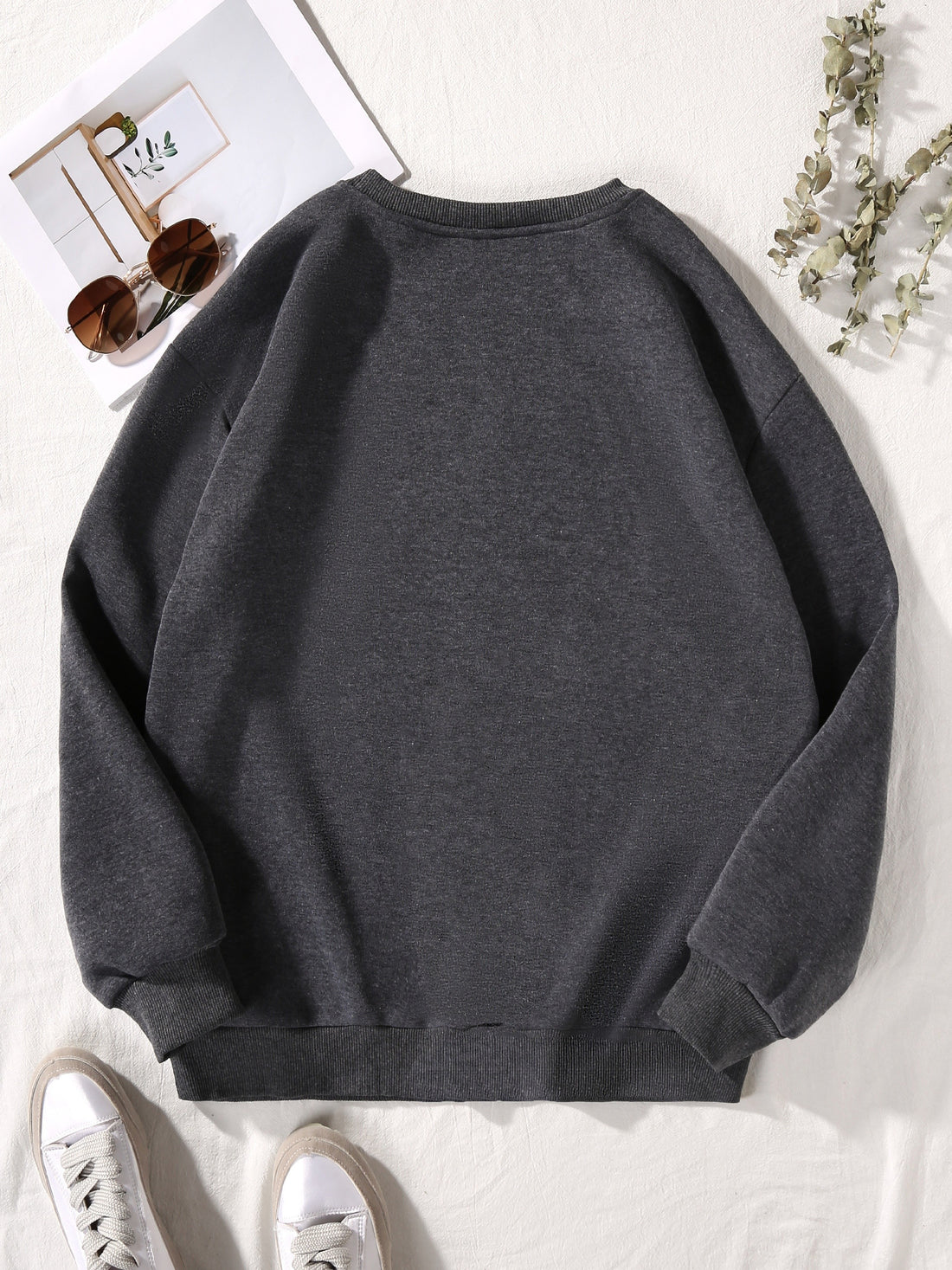This pullover sweatshirt is both cozy and cute, featuring a fun and playful cartoon character print. Perfect for fall and winter, add a touch of personality to your wardrobe with this fashionable sweatshirt. Stay warm and stylish with this must-have piece.